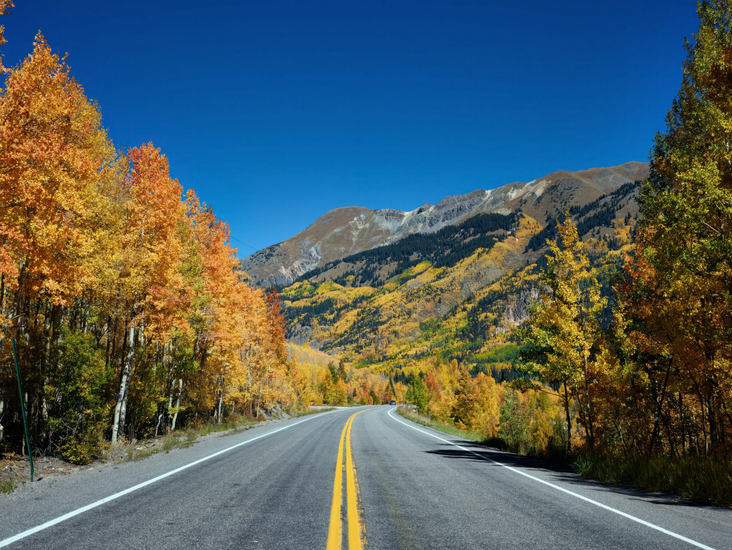 A winding, cliffside section of the Million Dollar Highway offering breathtaking mountain views between Silverton and Ouray.