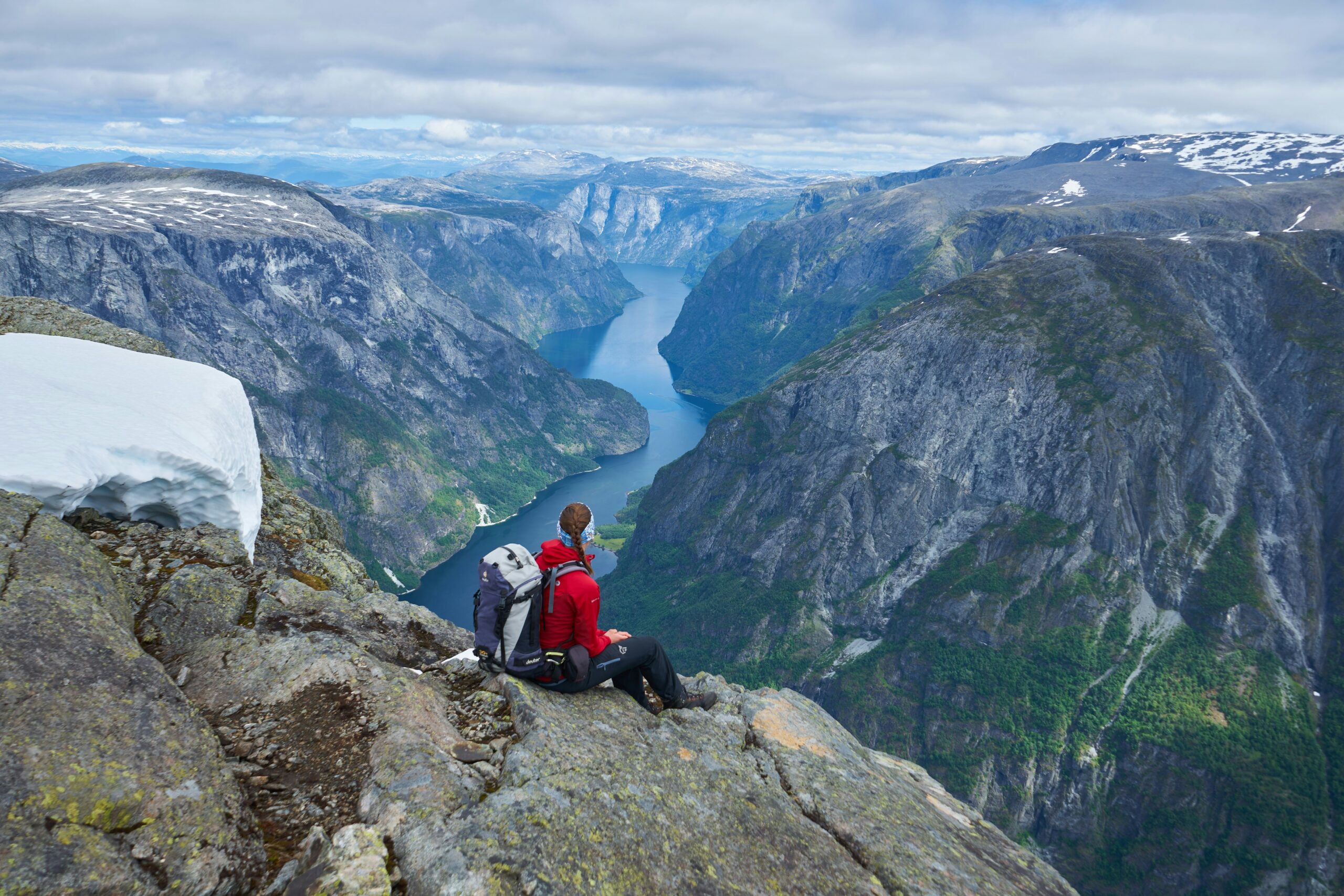 Narrow UNESCO listed Nærøyfjord with waterfalls and steep cliffs, one of the most iconic natural scenes in this Scandinavia Travel Guide.