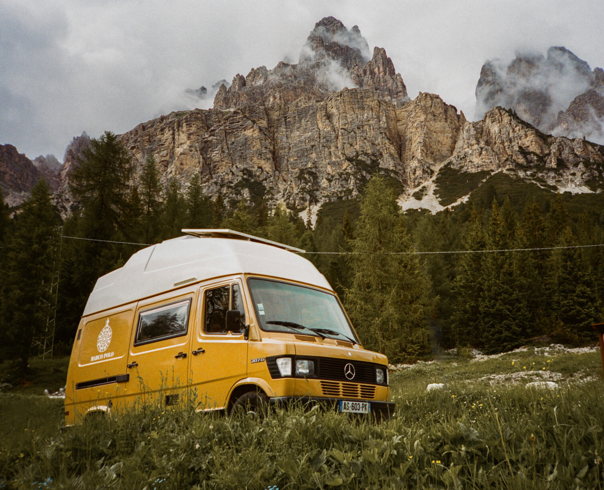 Scenic road trip photography featuring a camper van in the Italian Dolomites, illustrating immersive travel experiences.